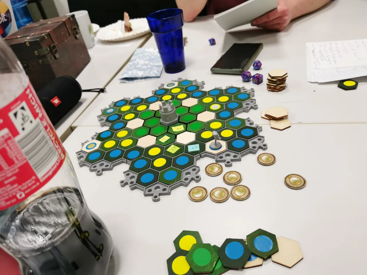 GRIMA playtest: hex forest board with tower, figure and coin tokens