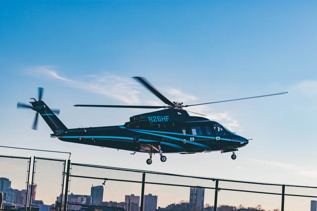Helicopter lifting off from a rooftop helipad